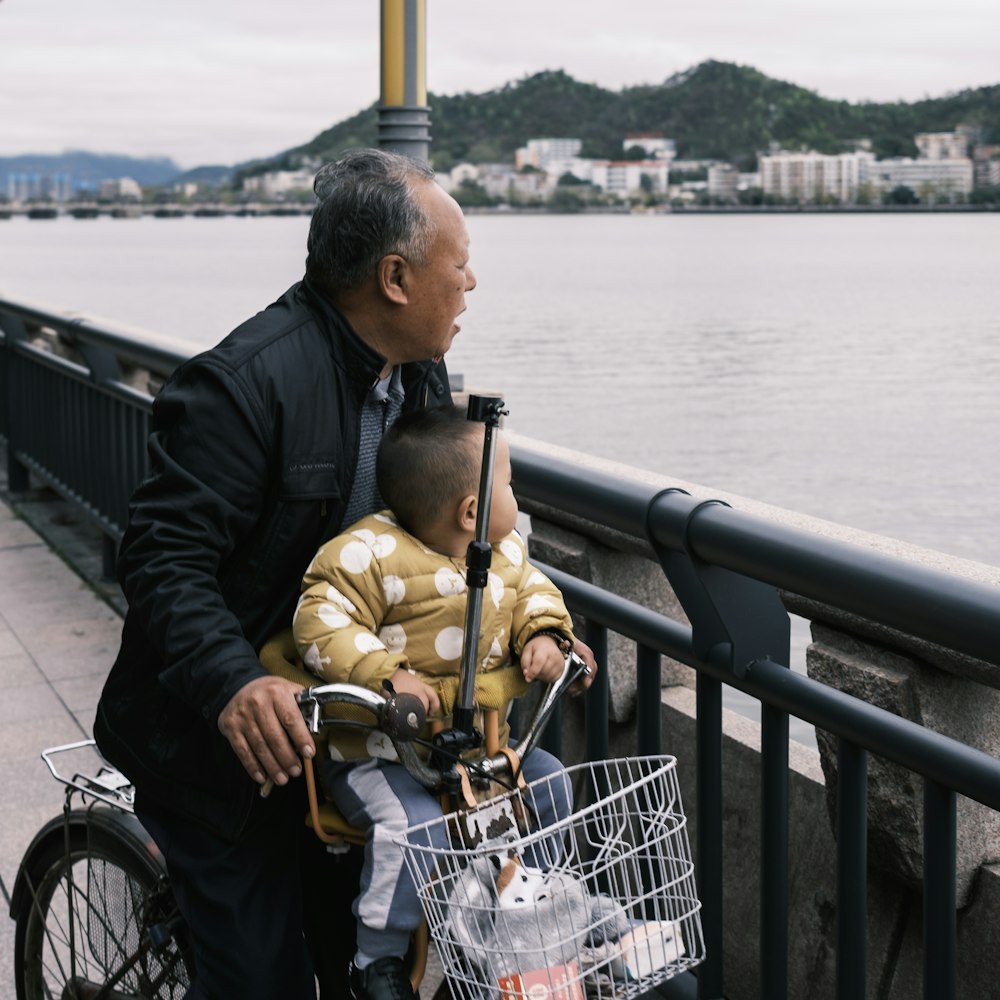 a man on a bike with a child in a basket