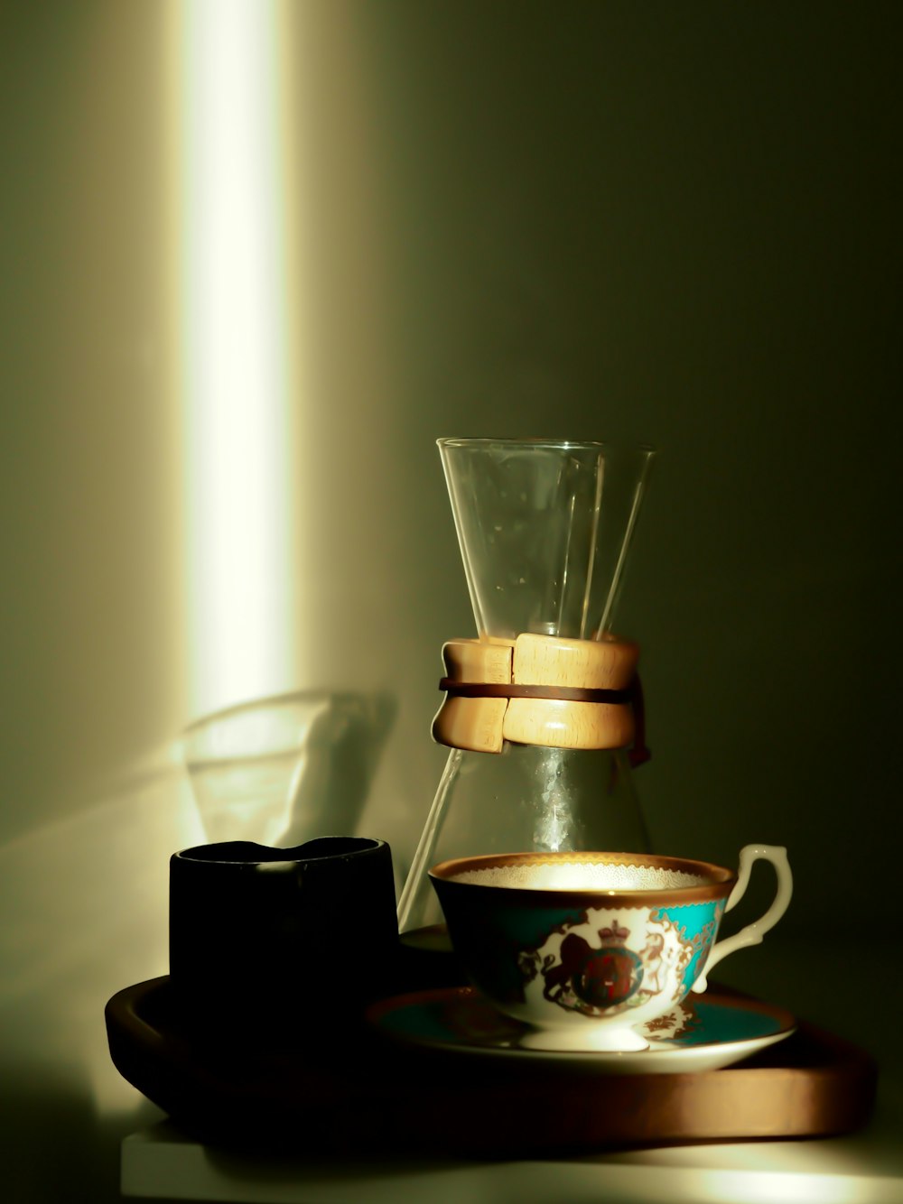 a coffee pot and a cup on a table