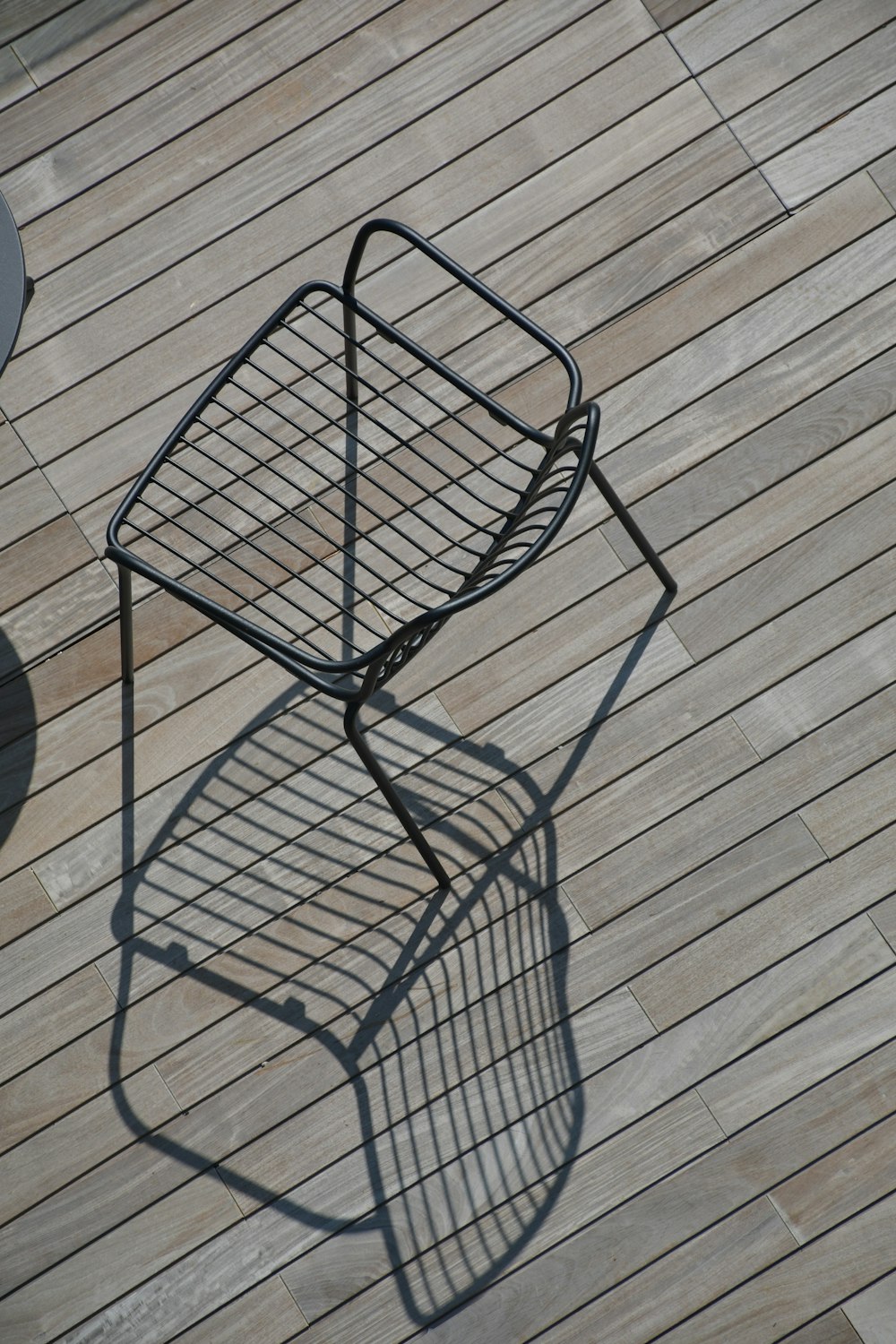 a metal chair sitting on top of a wooden floor