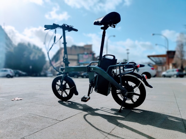 A compact folding electric bike ready for transport.