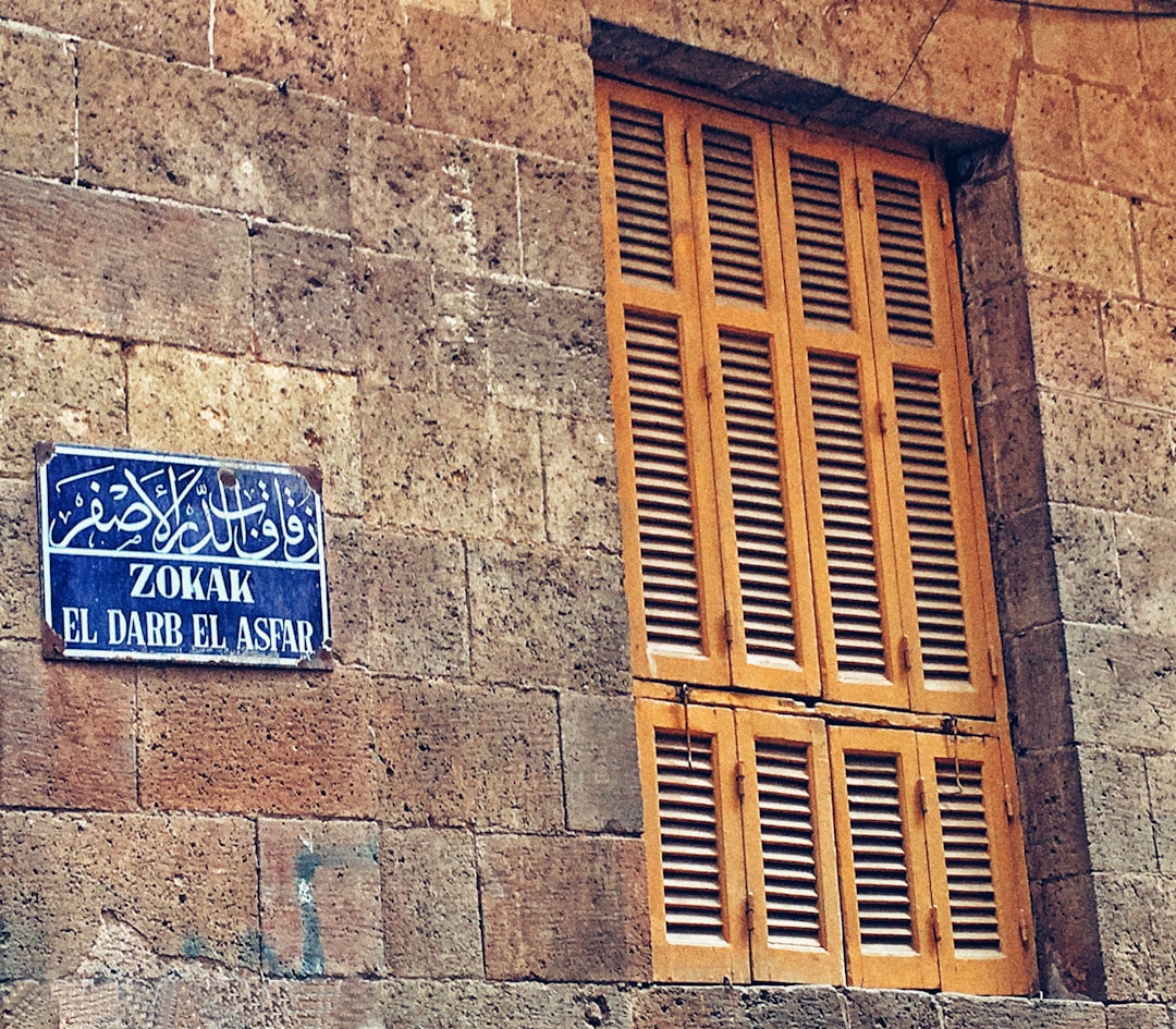 a blue street sign mounted to the side of a building,