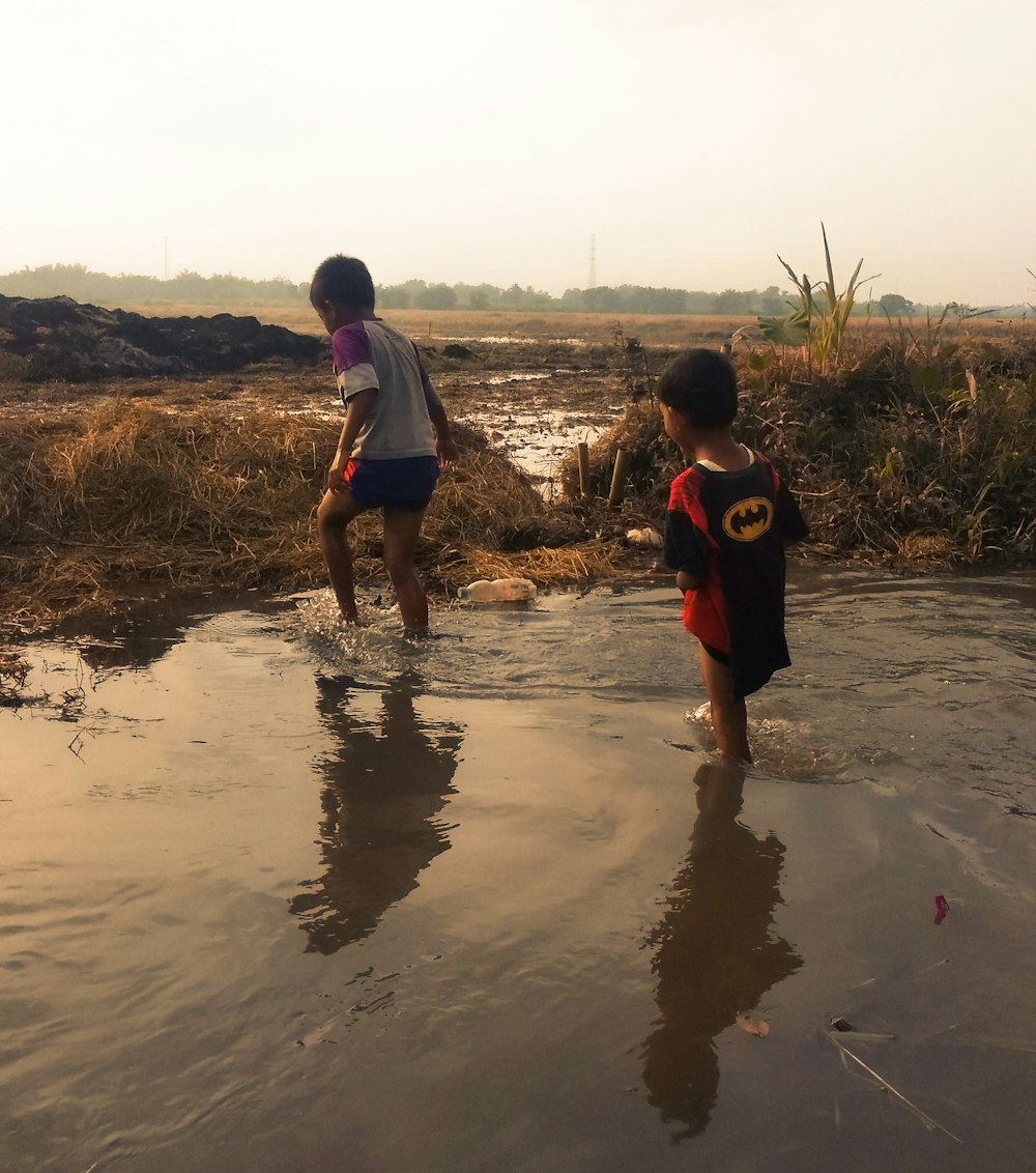 a couple of kids playing in some water