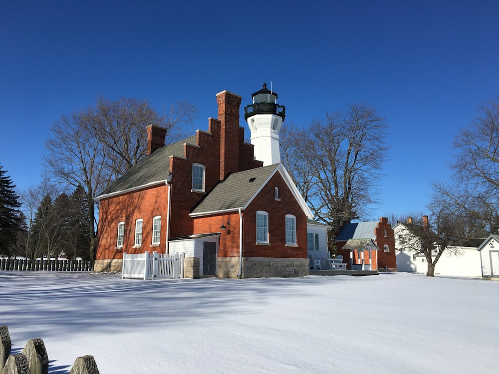 a red brick building with a white and black light house