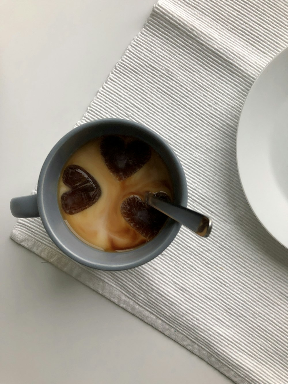 a cup of coffee with a spoon in it