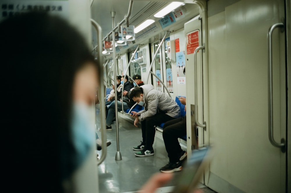 a group of people riding on a subway train