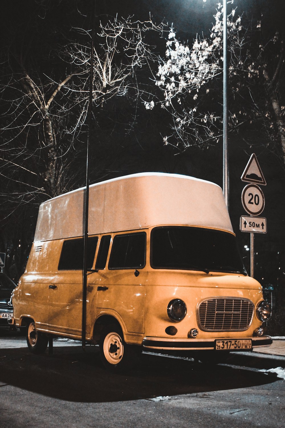an old yellow bus parked on the side of the road
