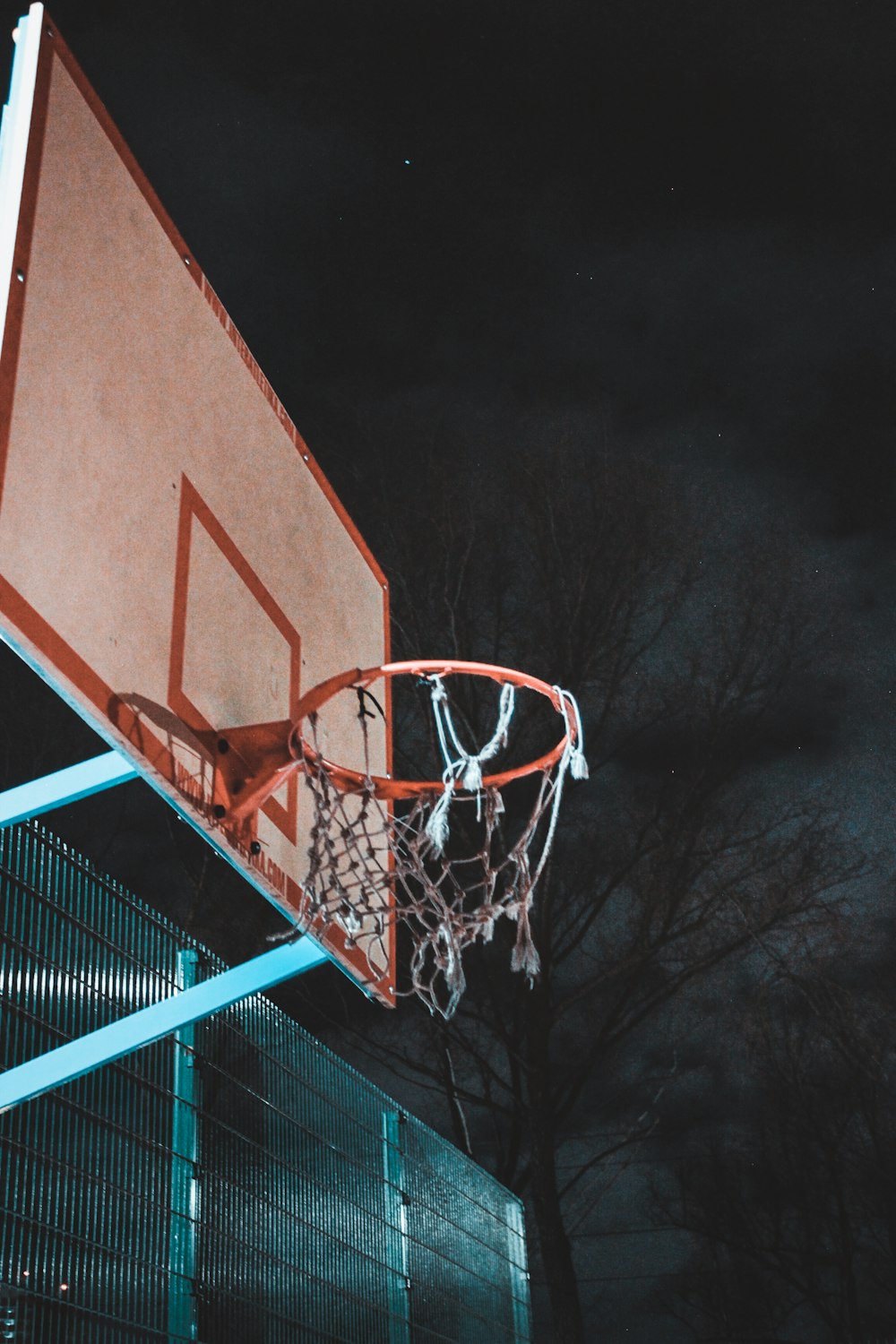 a basketball going through the hoop of a basketball court