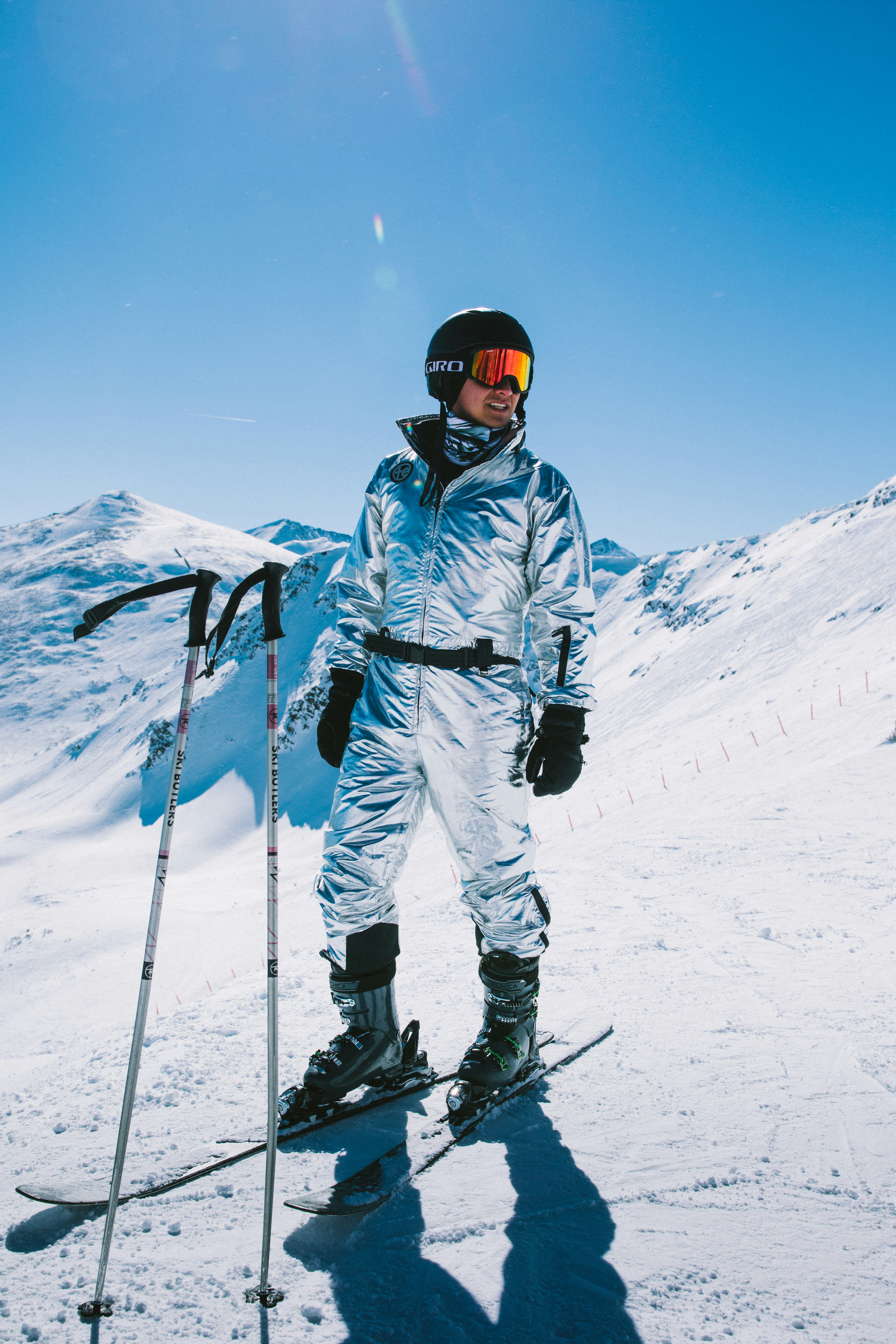 a man standing on top of a snow covered slope