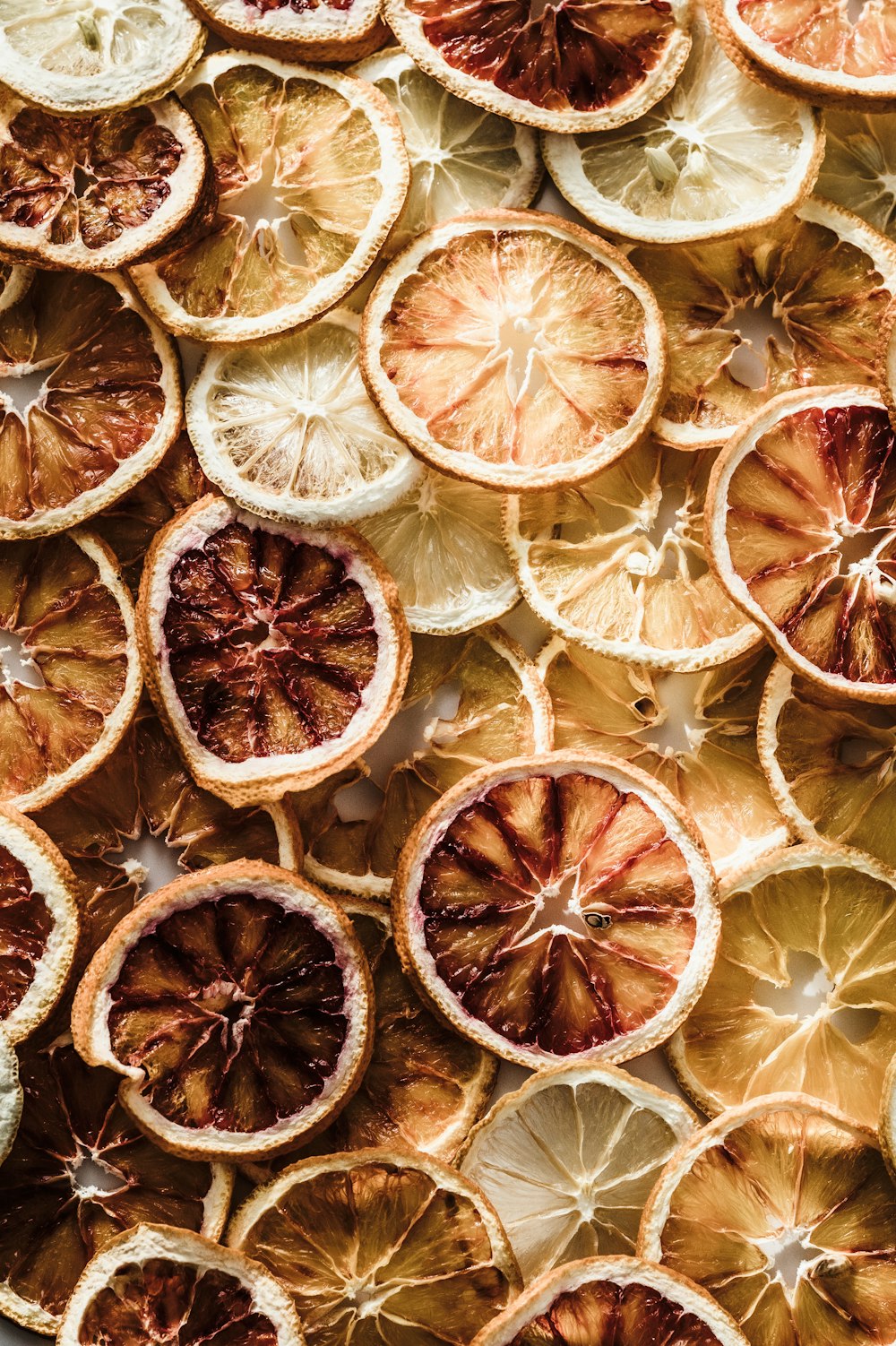 a bunch of oranges cut in half on a table