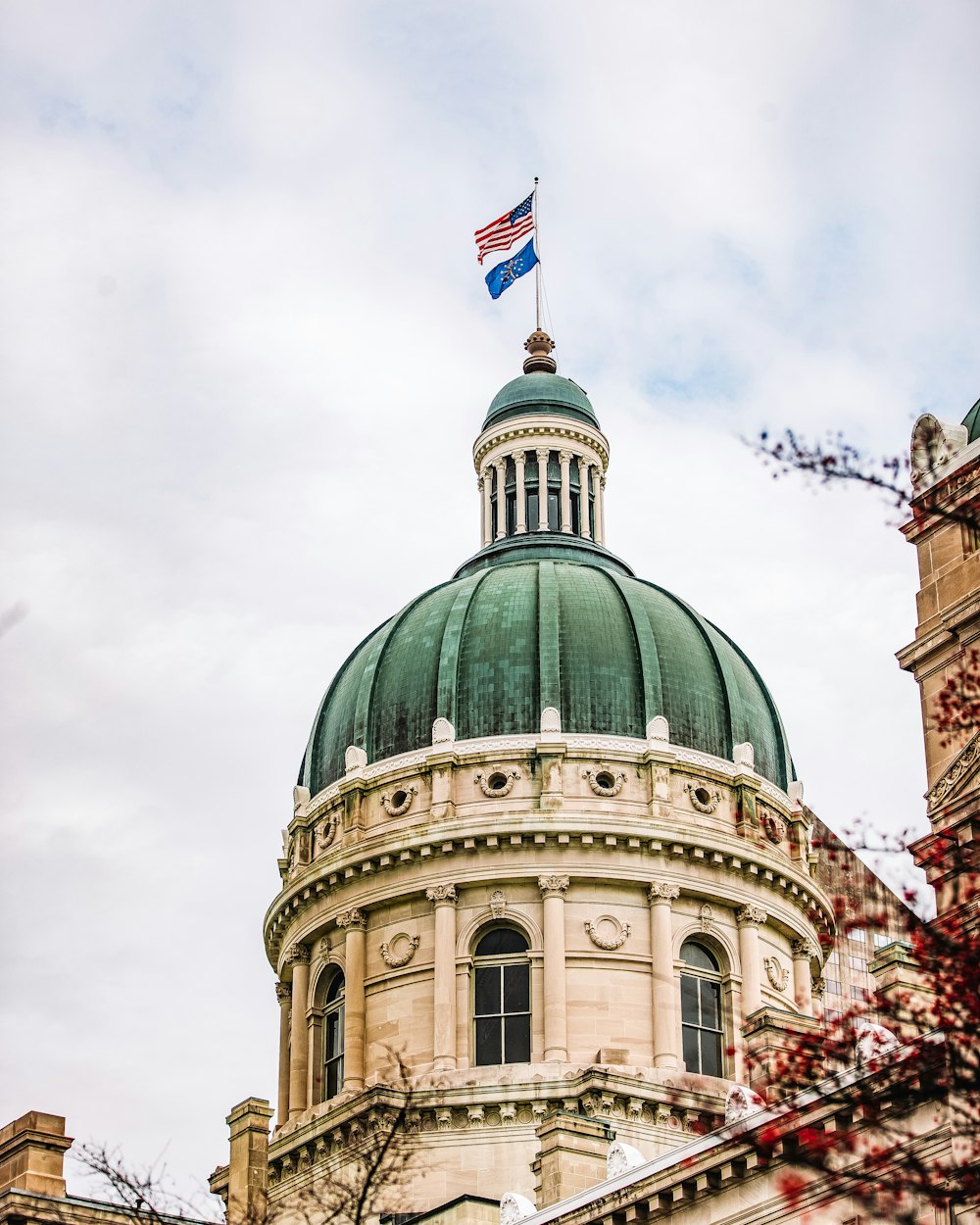 a building with a green dome and a flag on top