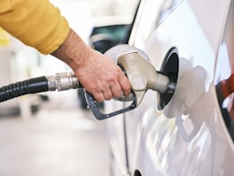 a man pumping gas into his car at a gas station