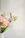 Close-up of a fresh floral arrangement with pastel pink and white flowers, perfectly arranged in a rustic vase.