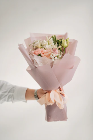 a person holding a bouquet of flowers in their hand