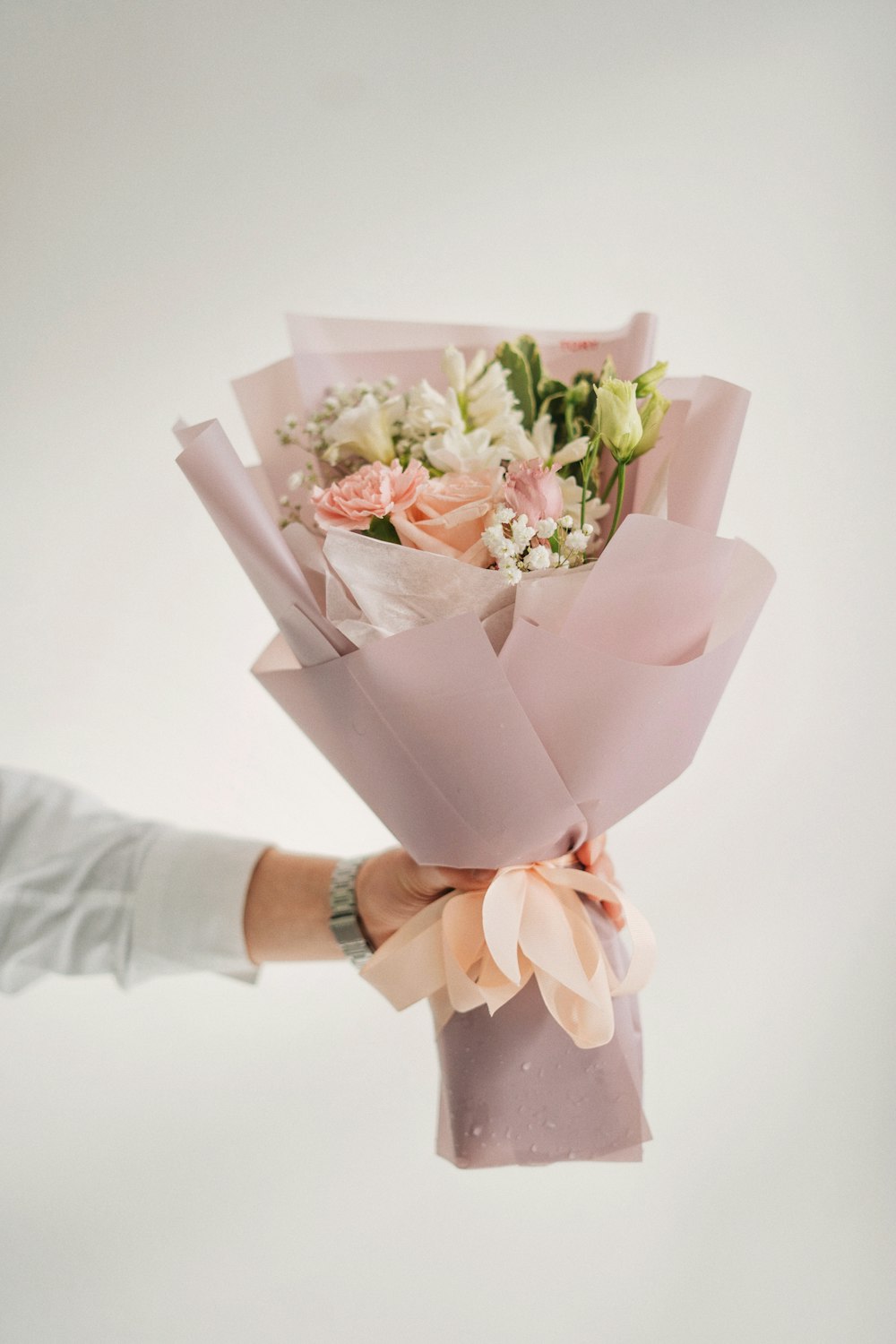 a person holding a bouquet of flowers in their hand