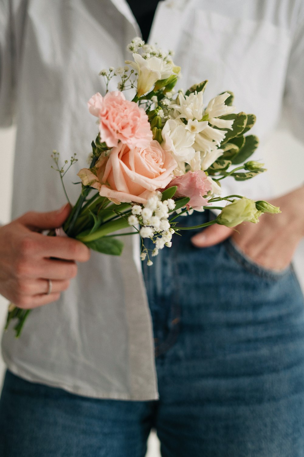 a person holding a bouquet of flowers in their hands