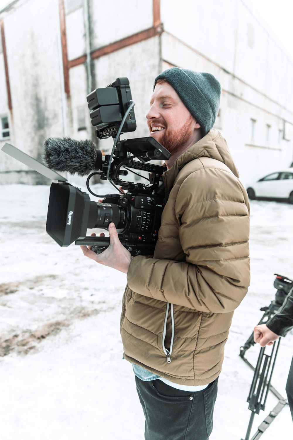 a man holding a camera and a microphone