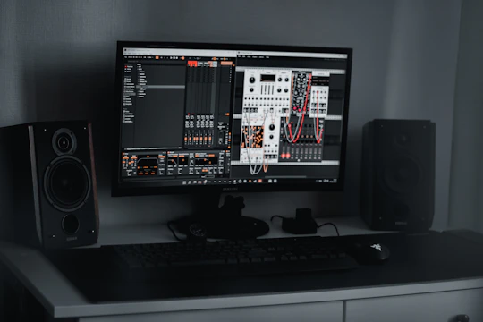 A sleek SDR setup with a laptop displaying spectrum analyzer software, glowing softly in a dark room.