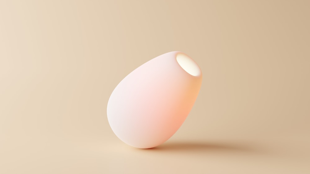 a white egg sitting on top of a table