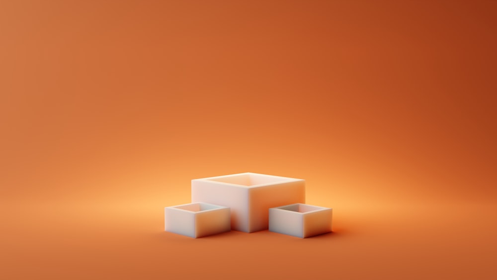 a group of white cubes sitting on top of a orange surface