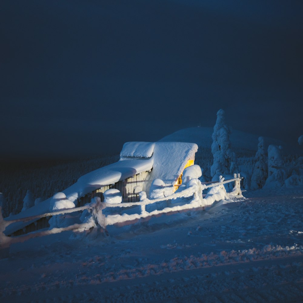 a house covered in snow on a hill