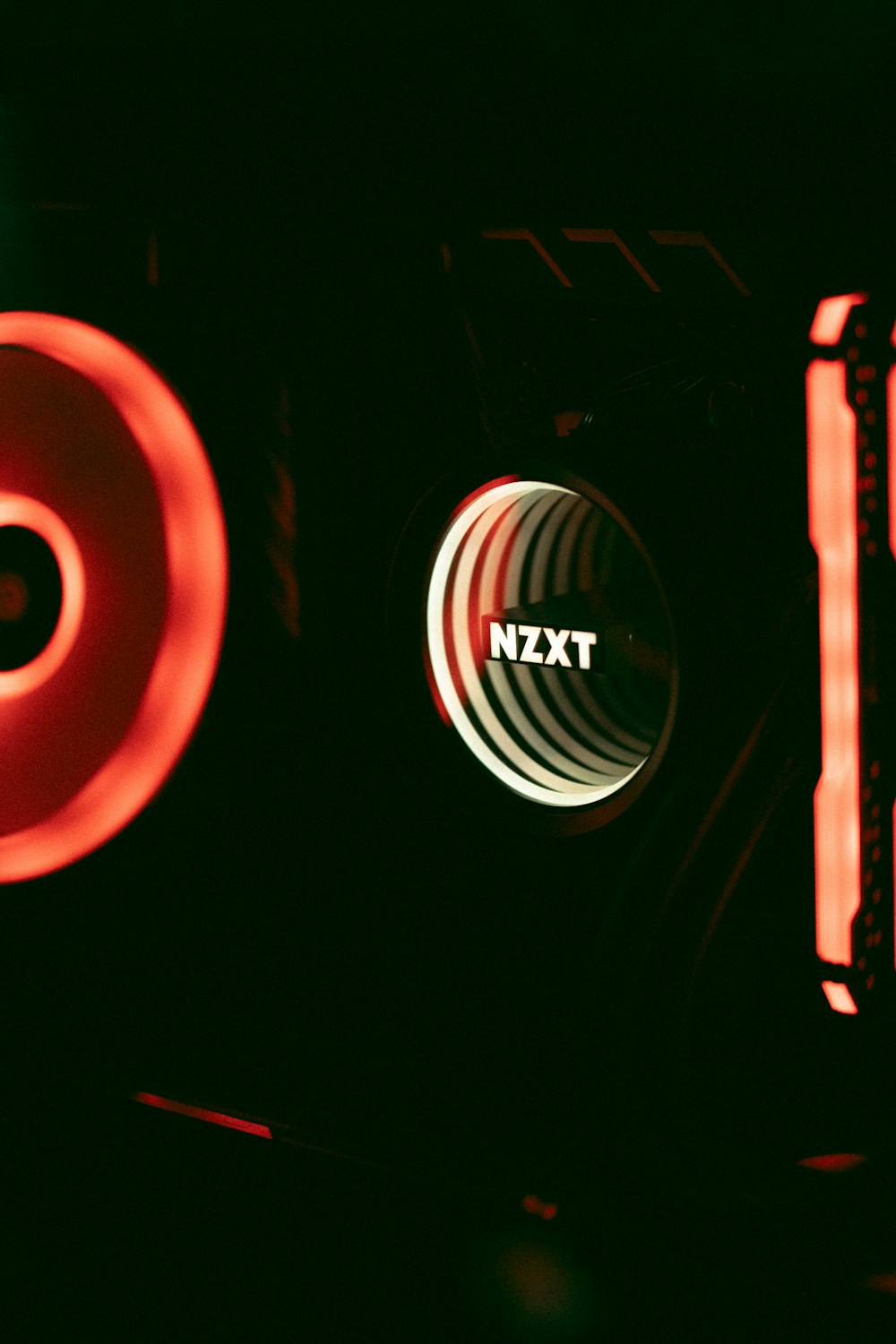 a close up of a speaker with a red light in the background