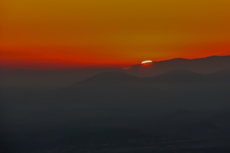 A vibrant sunset over a mountain range captured during a recent trip