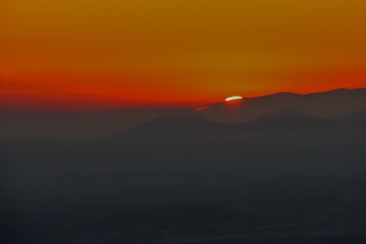 A vibrant sunset over a mountain range, captured during a recent trip.