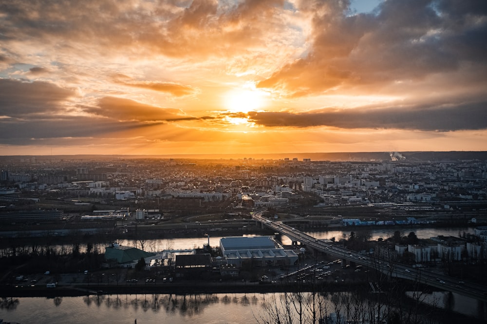 the sun is setting over a large city