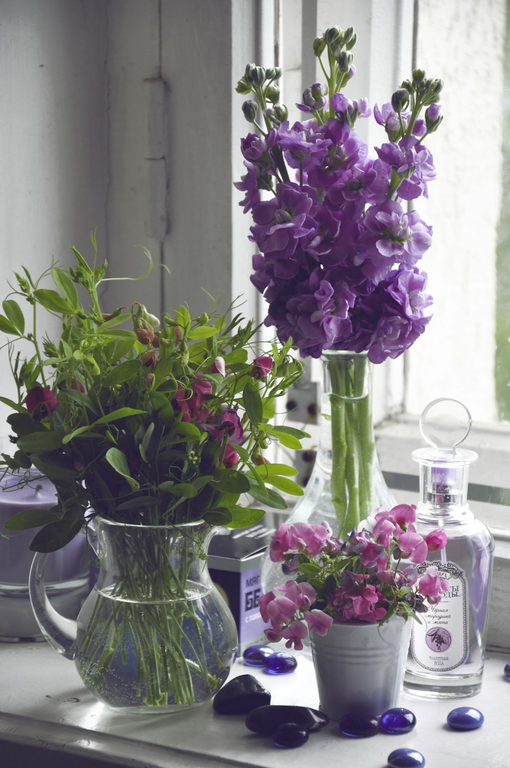 a table topped with vases filled with purple flowers