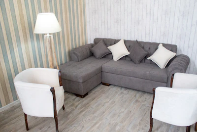 Cozy living room corner featuring vinyl flooring and soft gray curtains