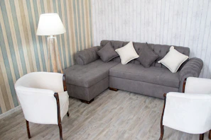 A cozy living room corner with built-in custom cabinets painted in soft gray tones.