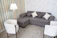 Cozy living room corner with a linen sofa cover and soft cushions in warm tones.