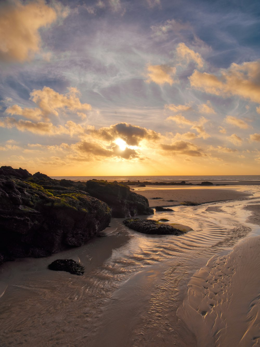 a group of clouds in the sand on a beach