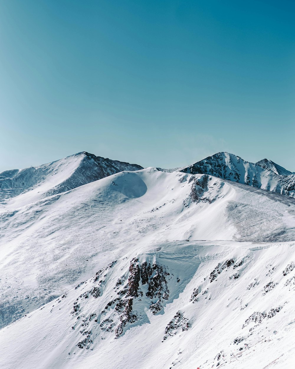 a person riding skis on a snowy surface