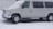 A white van is parked in a snowy environment, covered with a light dusting of snow. The snow is still falling lightly, creating a cold and wintry atmosphere.