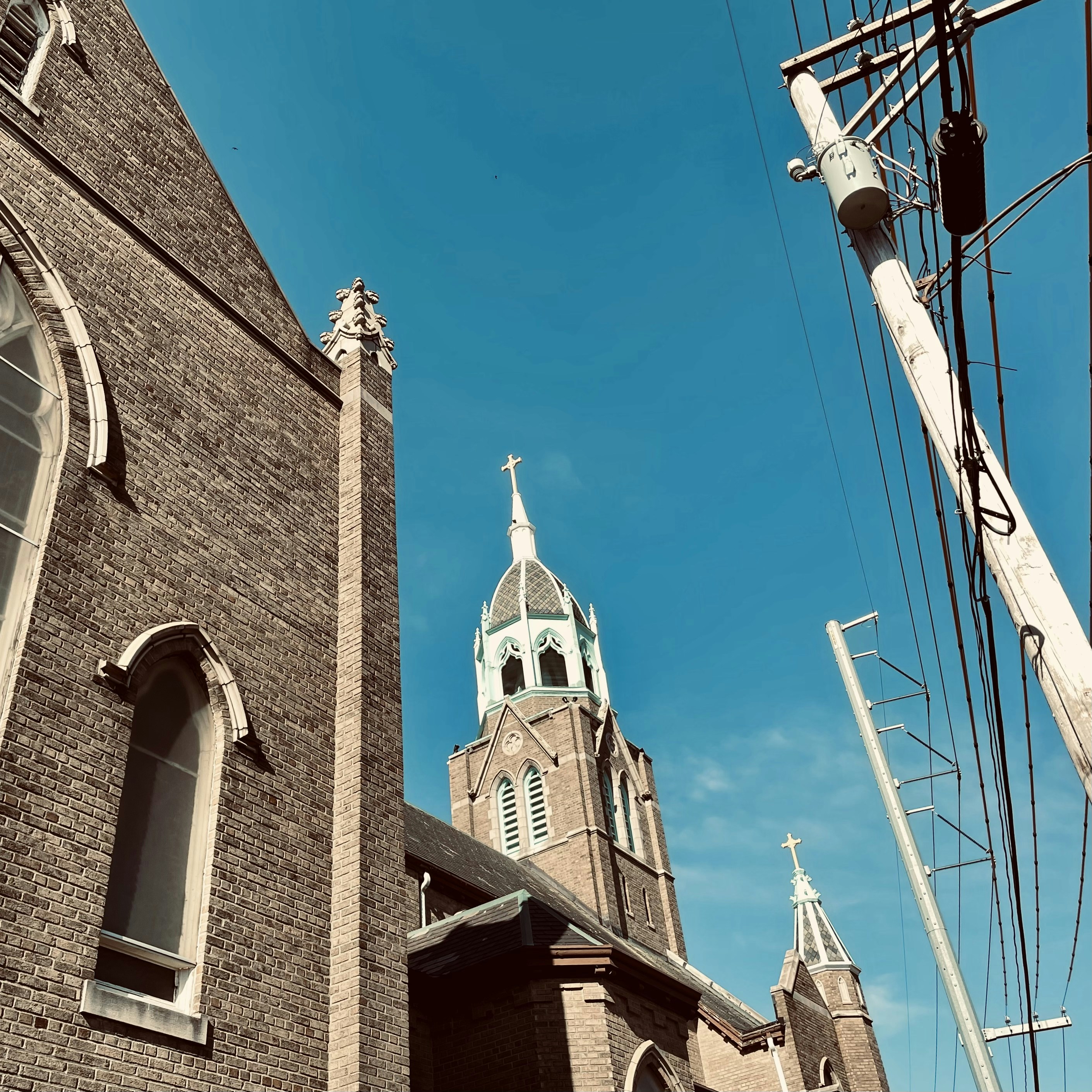 a church with a steeple on a sunny day