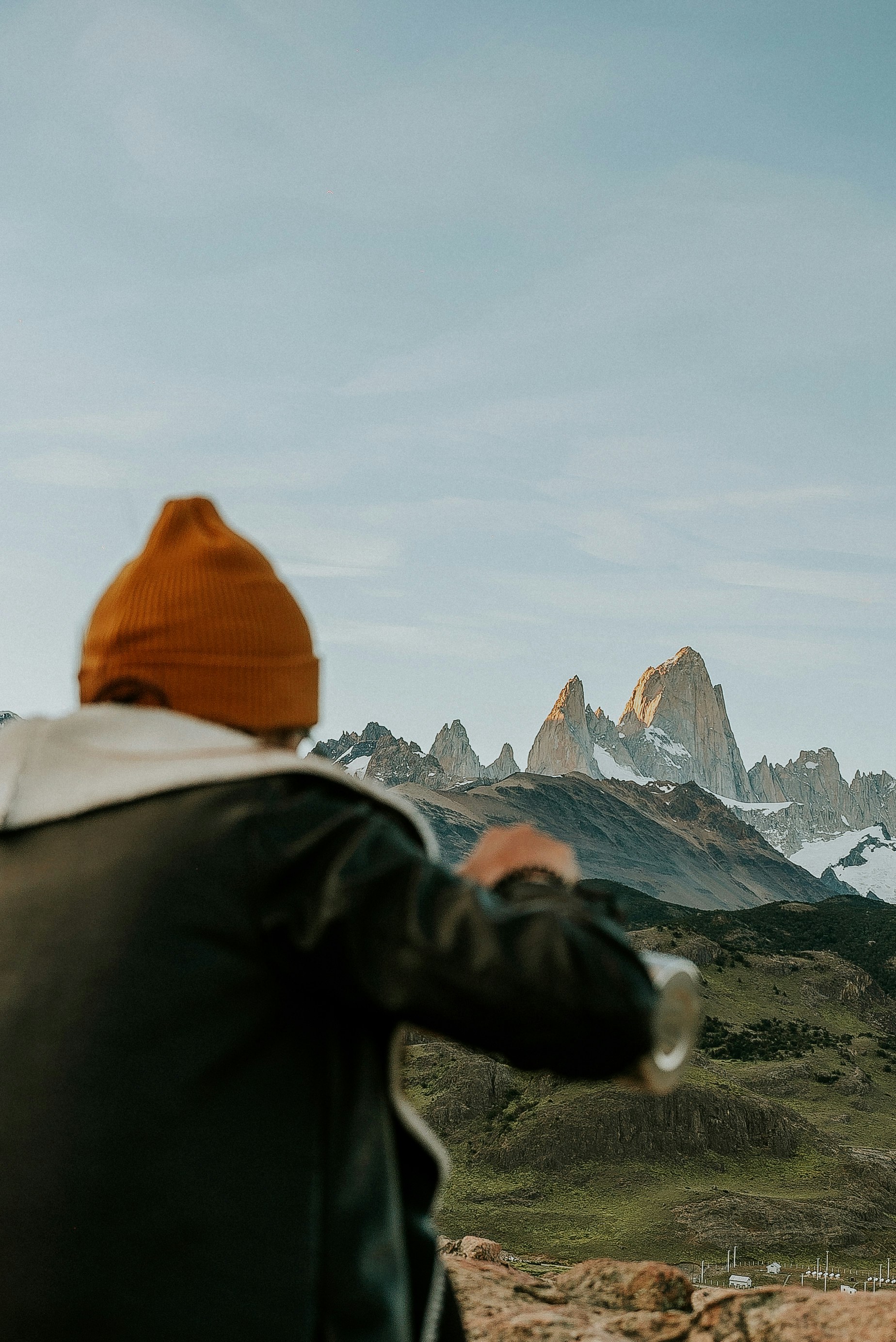 a man standing on top of a mountain looking at the mountains