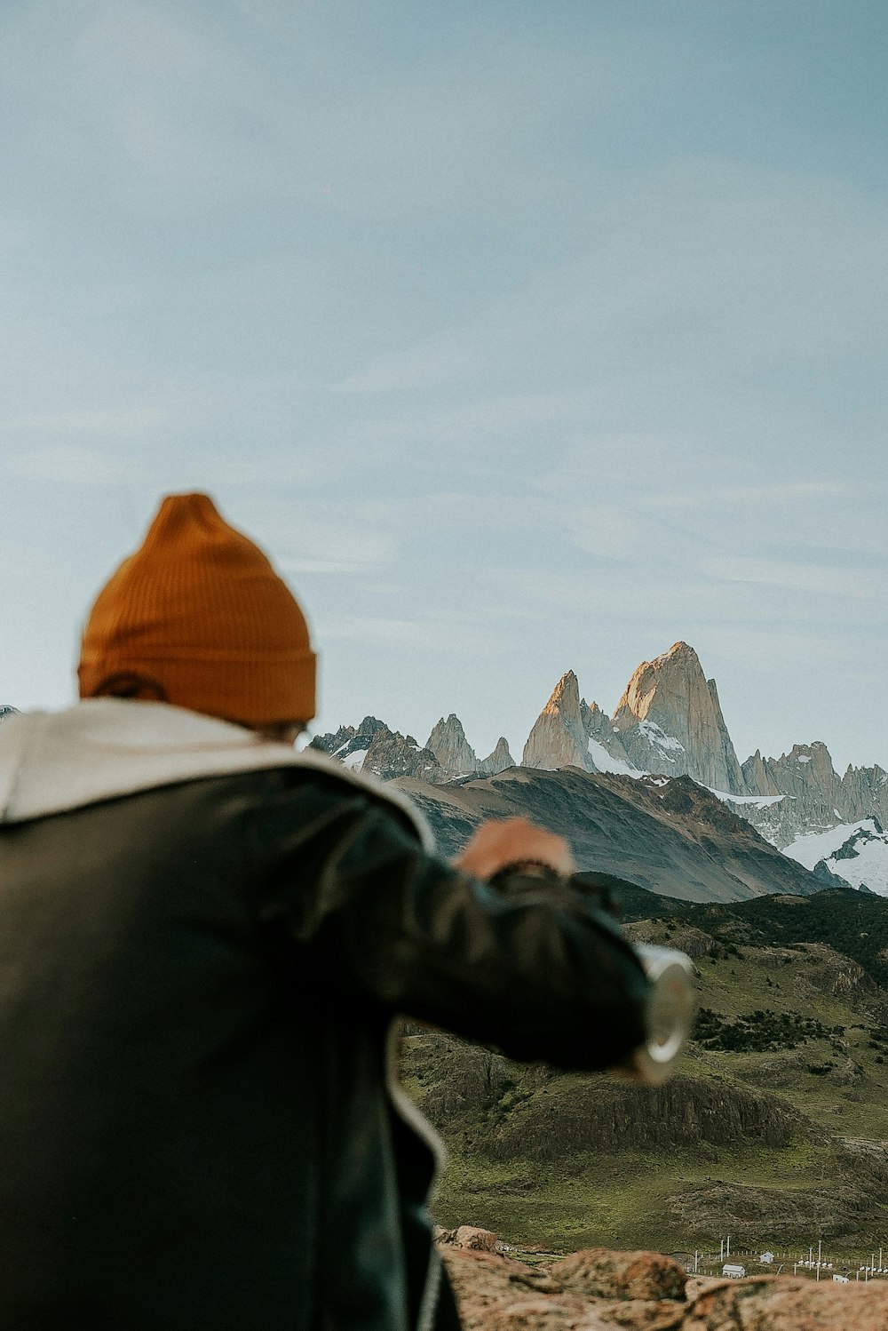 a man standing on top of a mountain looking at the mountains