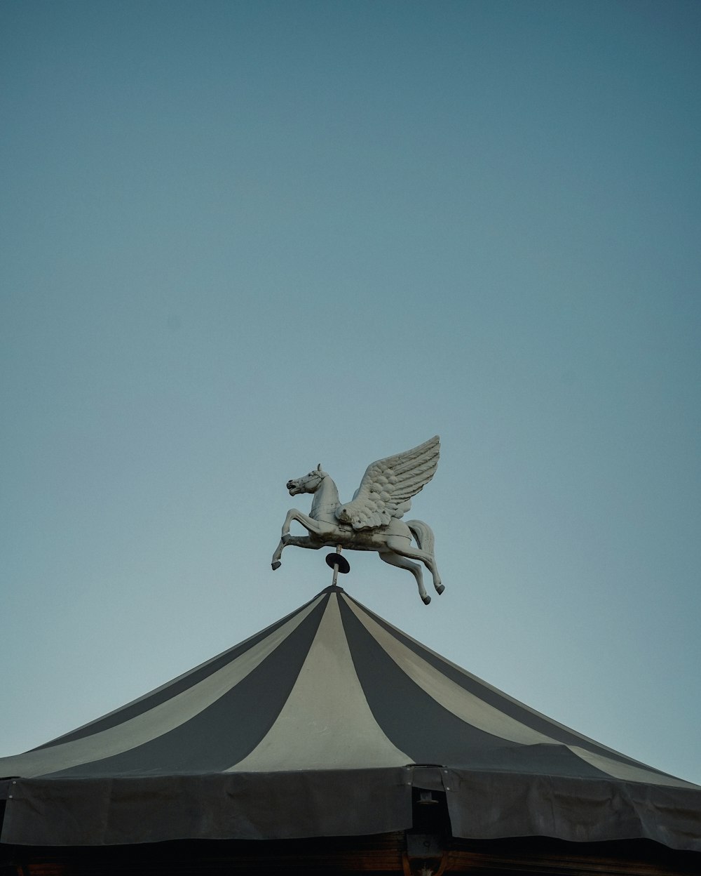 a statue of a horse on top of a tent