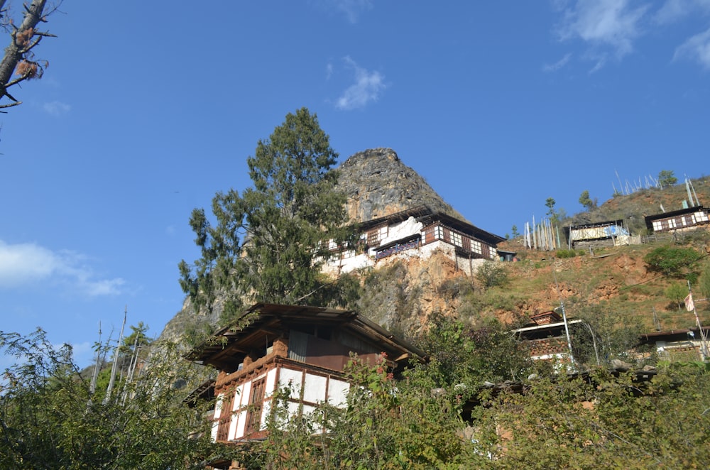 a house on a hill with a mountain in the background