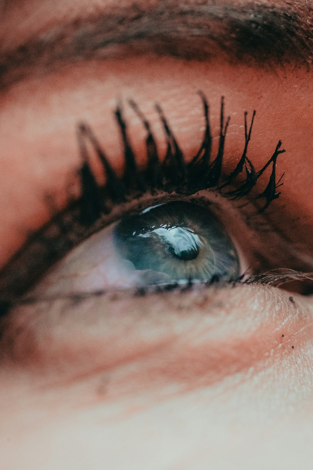a close up of a person's eye with long lashes