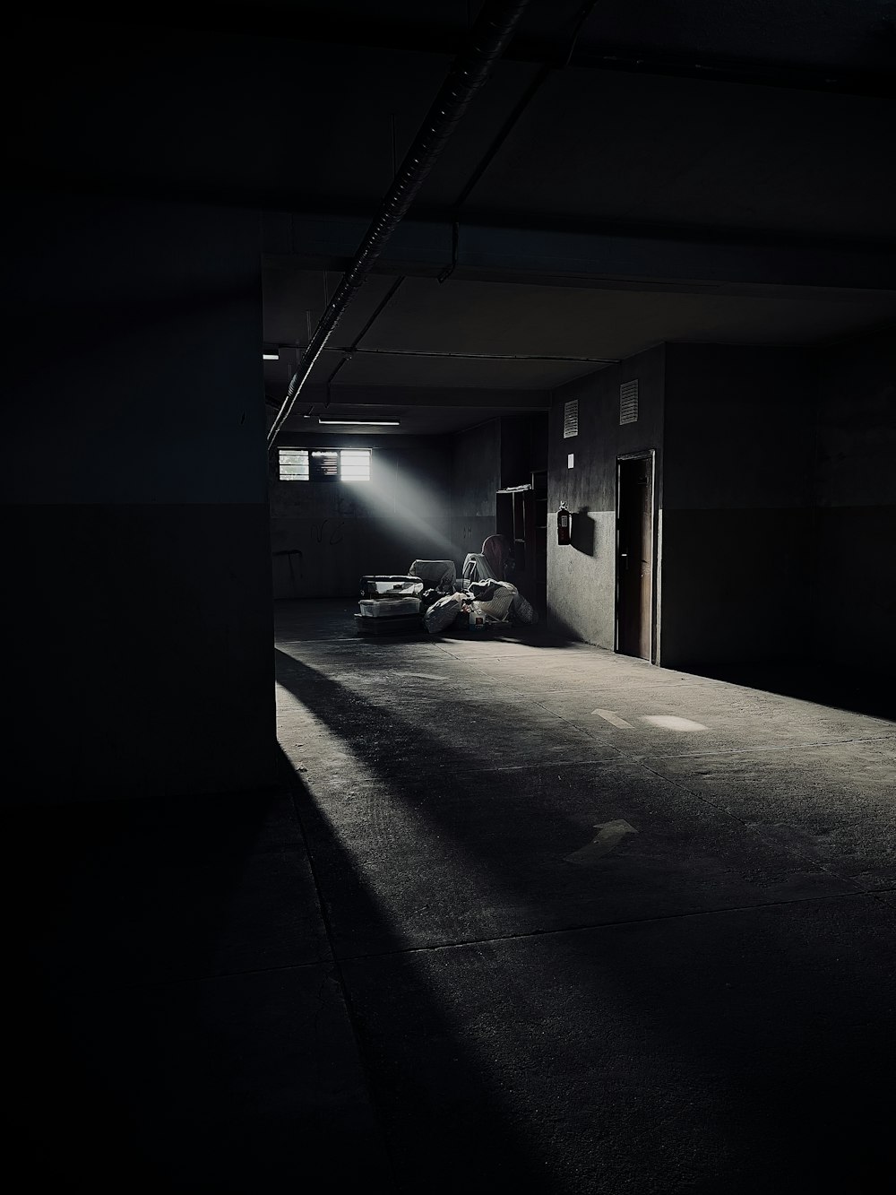 an empty parking garage with a car parked in it