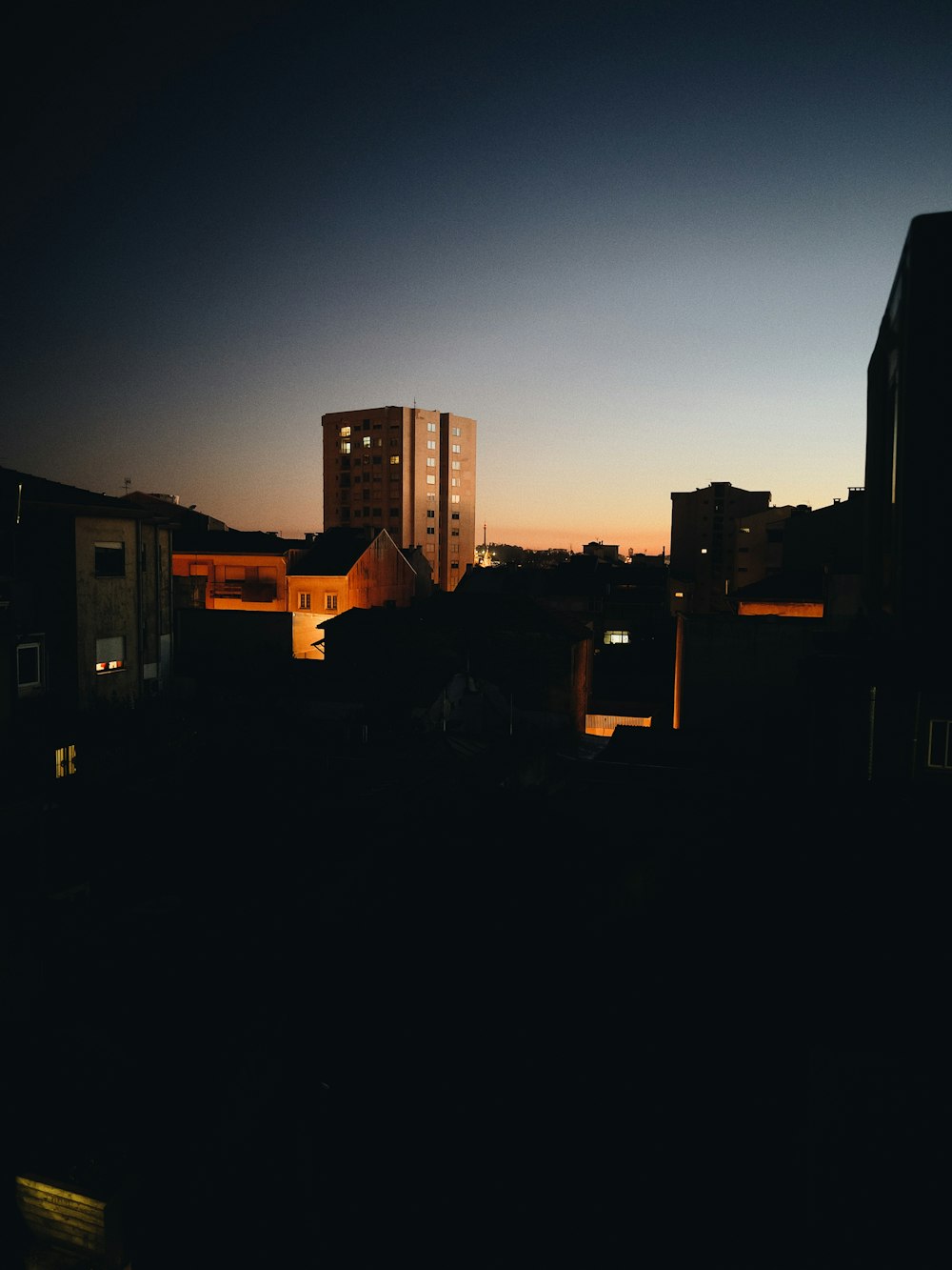 a city skyline at night with buildings lit up