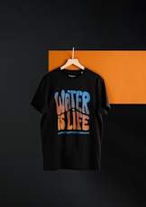 a black t - shirt hanging on a wall