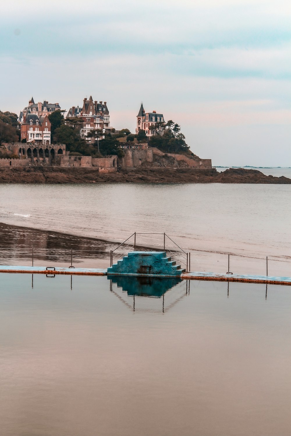 a blue boat sitting on top of a body of water