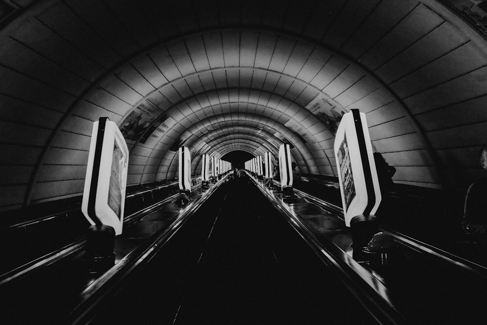 a black and white photo of an escalator