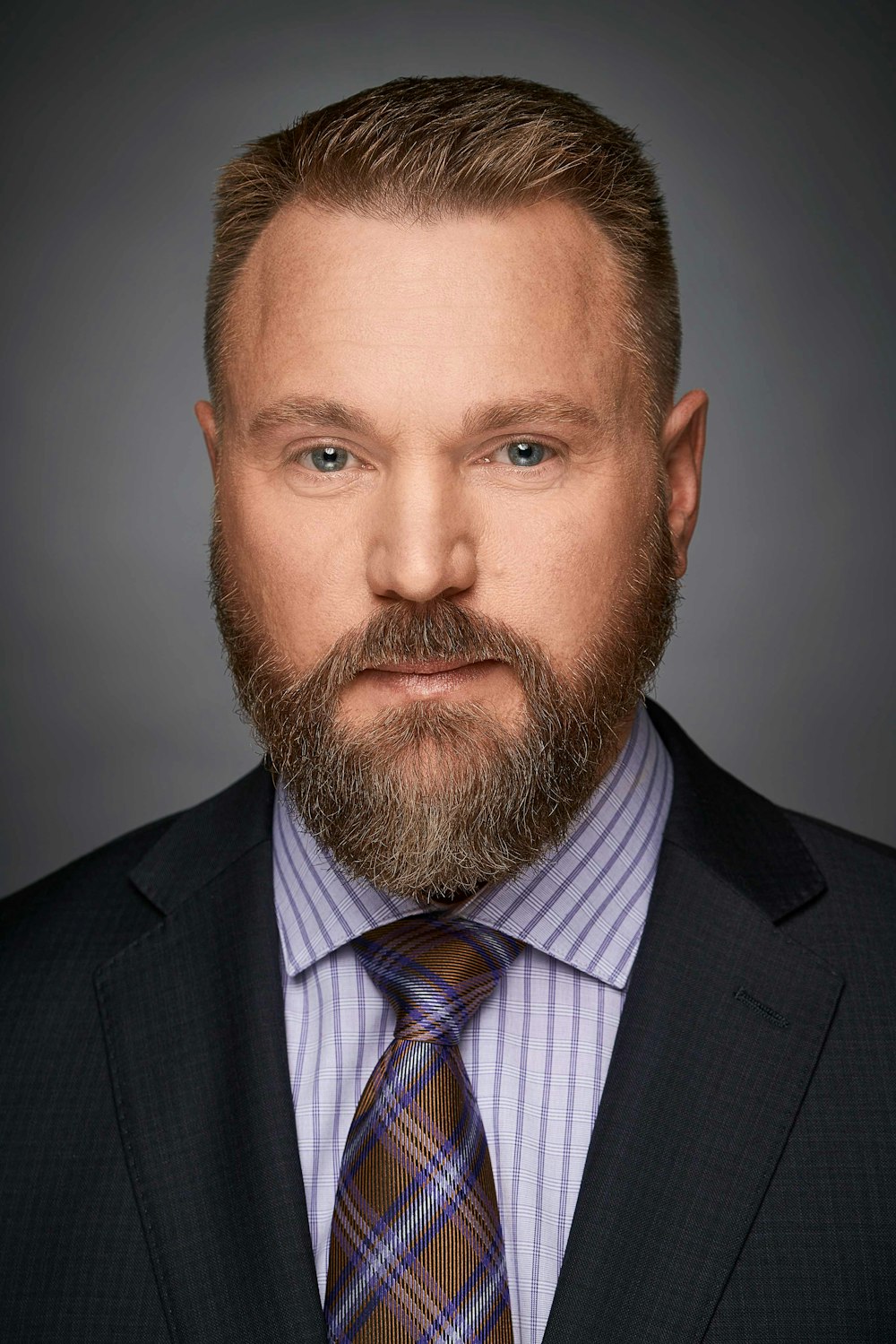 a man with a beard wearing a suit and tie