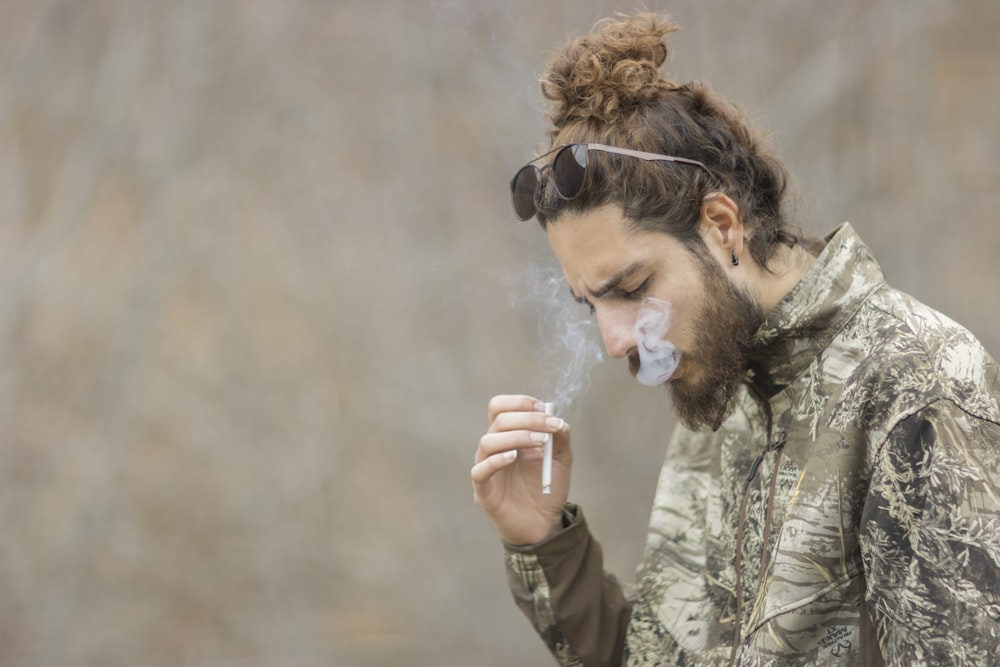 a man with a beard smoking a cigarette