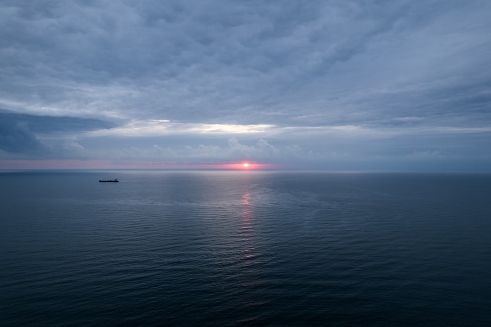 a large body of water under a cloudy sky