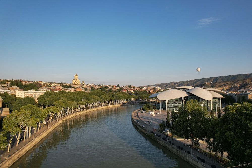 a river running through a city next to a forest